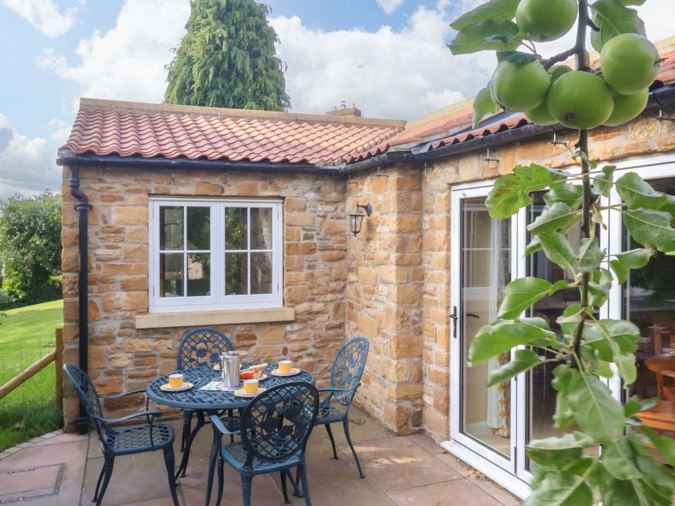 A patio with table and chairs at Apple Tree Cottage in York