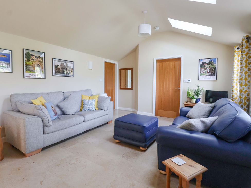 A living room with a sofa and coffee table at Apple Tree Cottage in York
