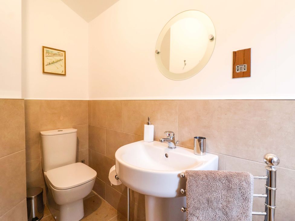 A bathroom with a toilet and sink at Apple Tree Cottage in York