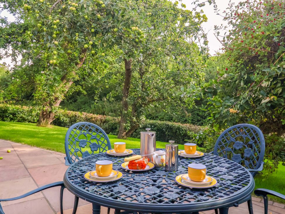A table set for tea with cups and a coffee pot at Apple Tree Cottage in York