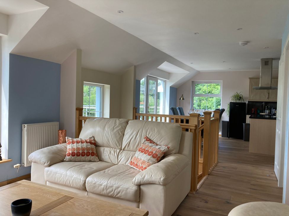 A living room with a sofa and table at 1 Bryn Beudy, Narberth