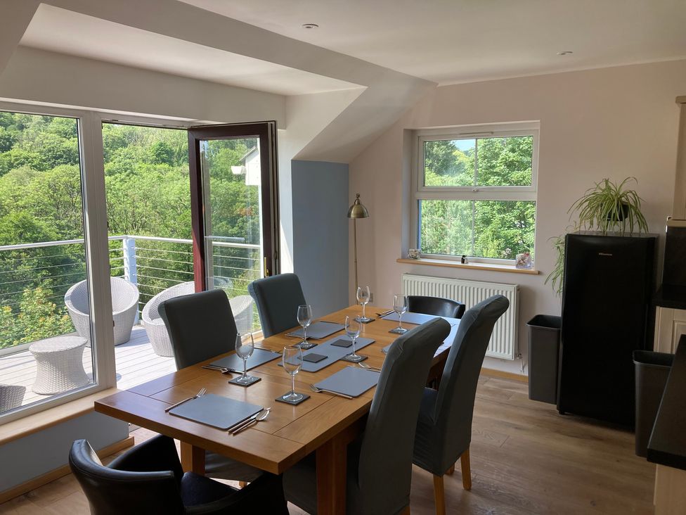 A dining room with a table set for dinner at 1 Bryn Beudy in Narberth