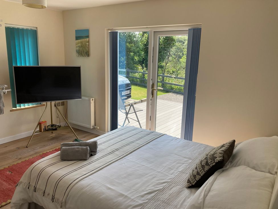 A bedroom with a bed and television at 1 Bryn Beudy in Narberth