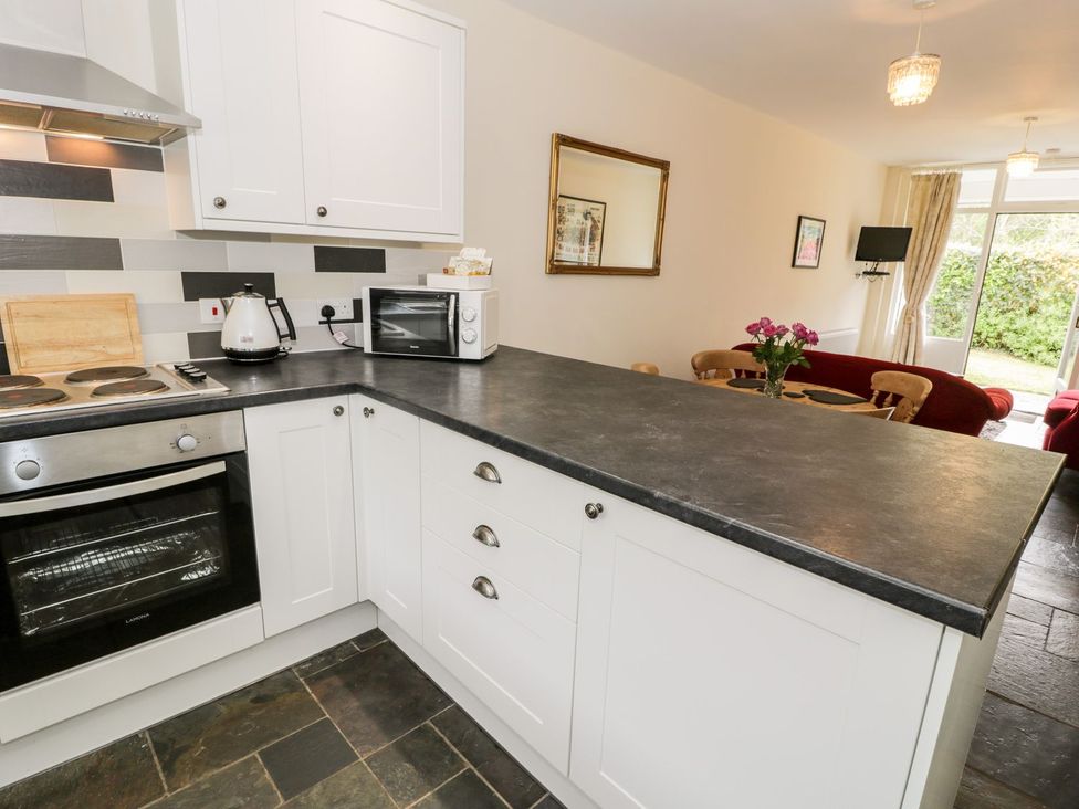 A kitchen with appliances and cooking area at 3 Riverside Bungalows in Llanbedr