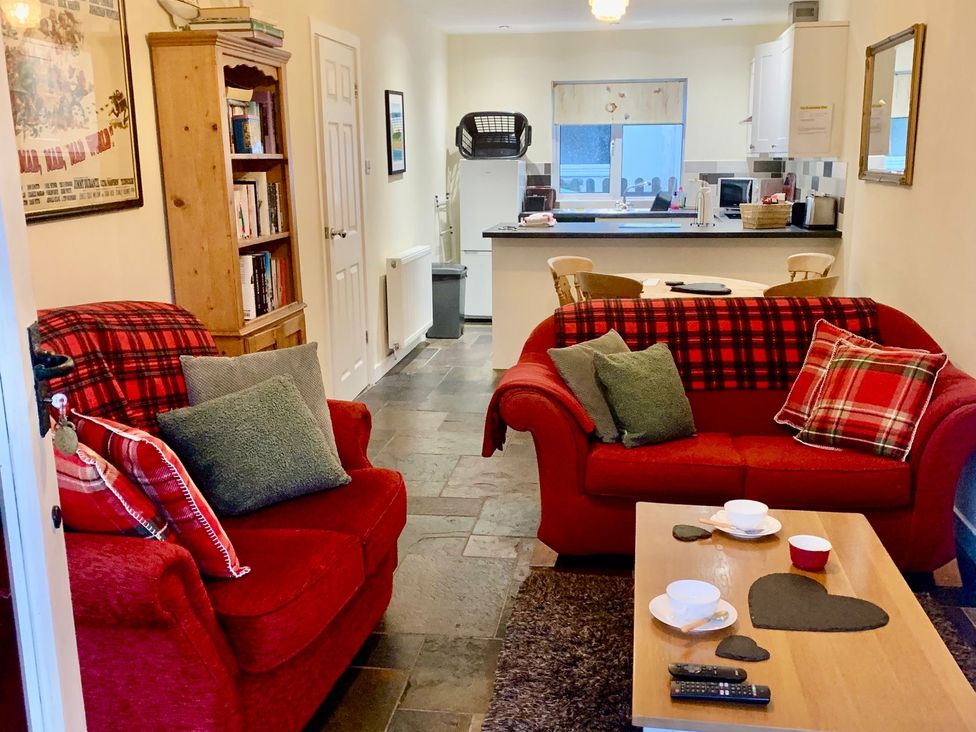 A living room with sofas and a coffee table at 3 Riverside Bungalows in Llanbedr