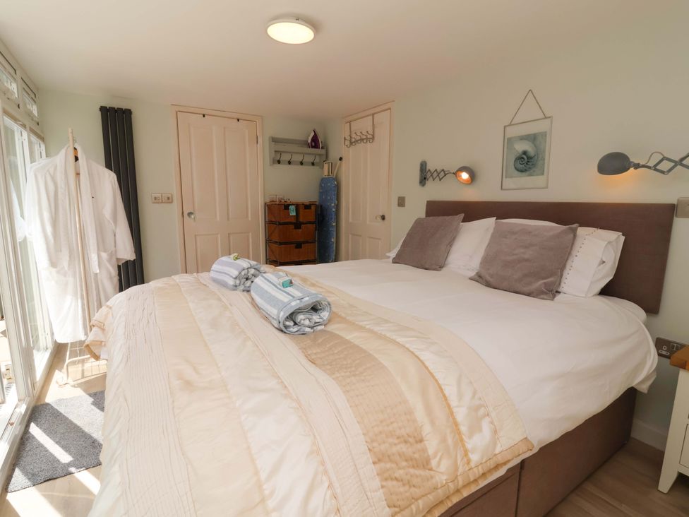 A bedroom with a bed and pillows at Sea Sanctuary