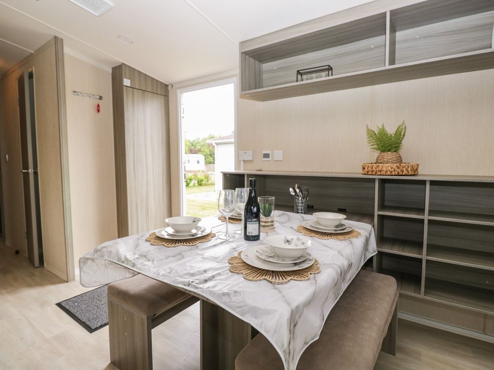 A dining room with a table set for a meal at Pinewood in Kidlington