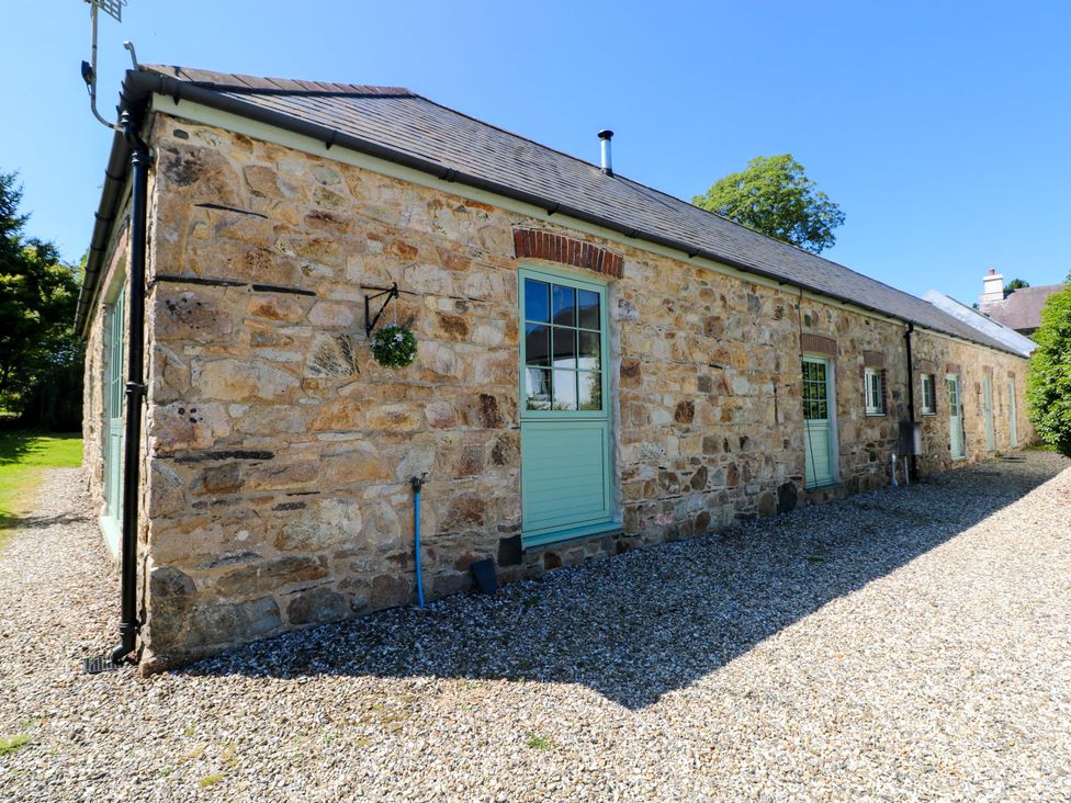 An exterior view of a stone building with a green door at Carreg Las Haverfordwest
