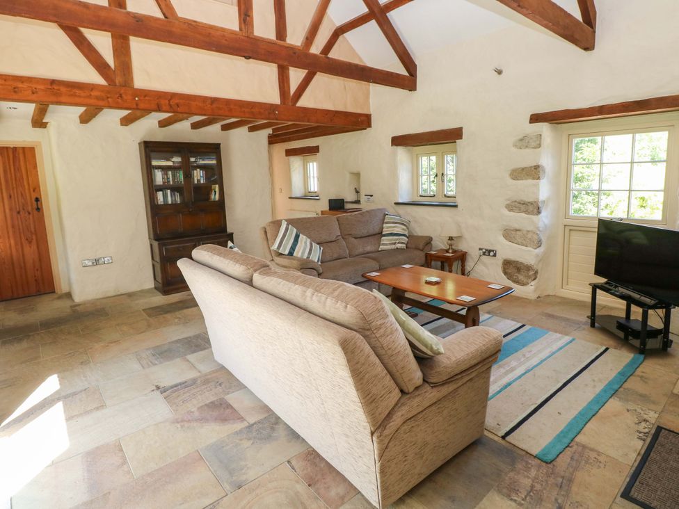 A living room with a sofa and coffee table at Carreg Las in Haverfordwest