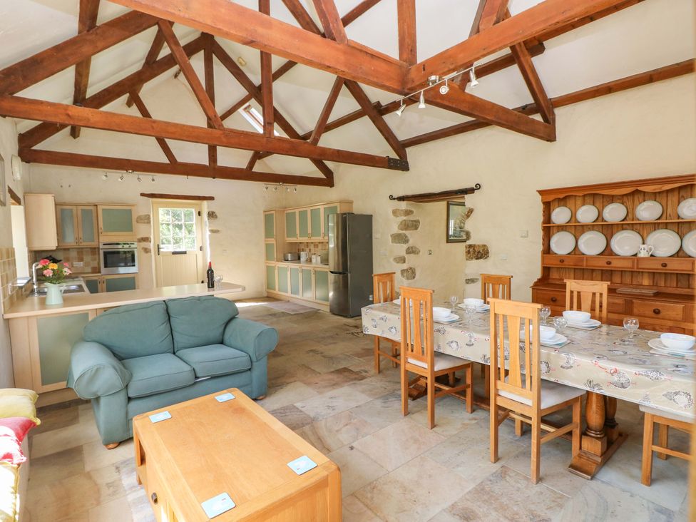 A kitchen with a dining table and sofa at Carreg Las in Haverfordwest