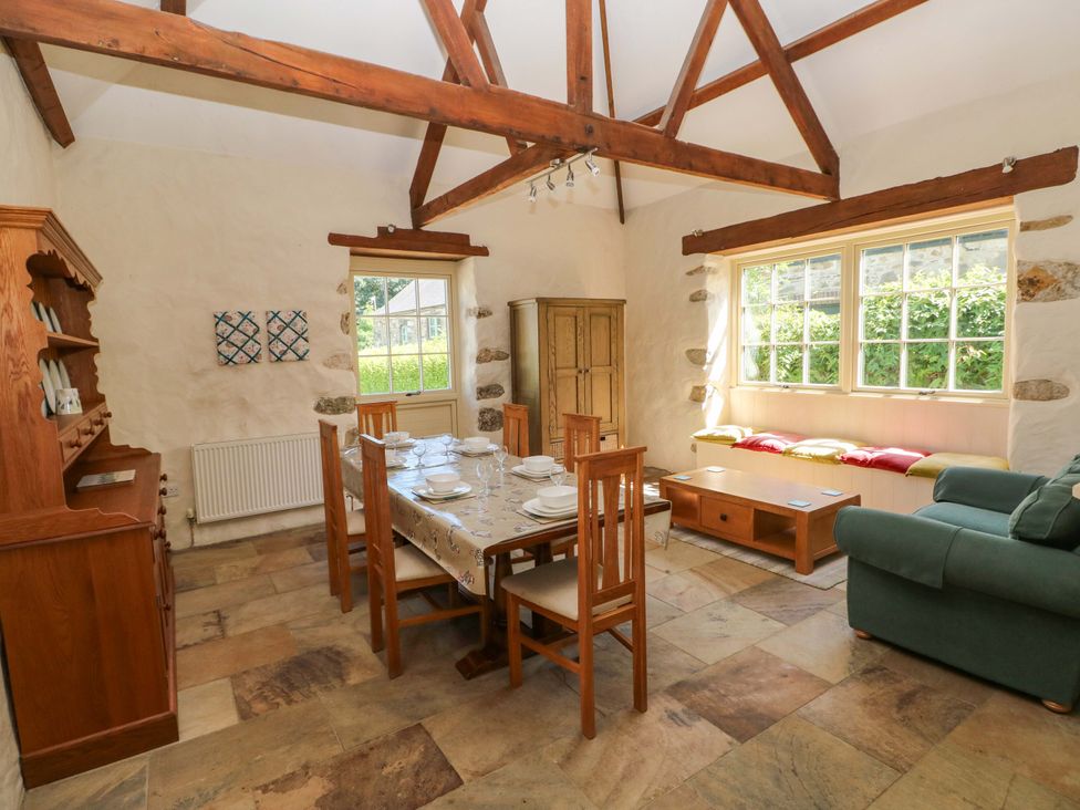 A dining room with a table and chairs and a sofa at Carreg Las Haverfordwest