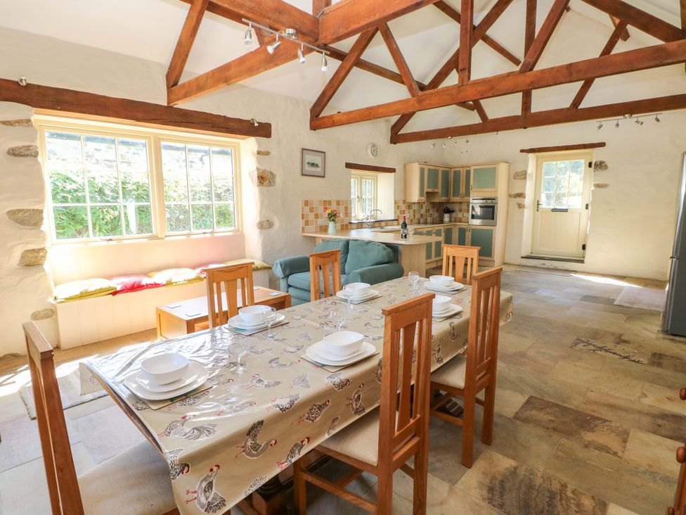 A kitchen with dining table and chairs at Carreg Las in Haverfordwest