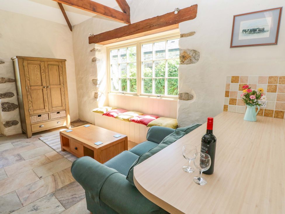 A living room with an armchair and coffee table at Carreg Las in Haverfordwest