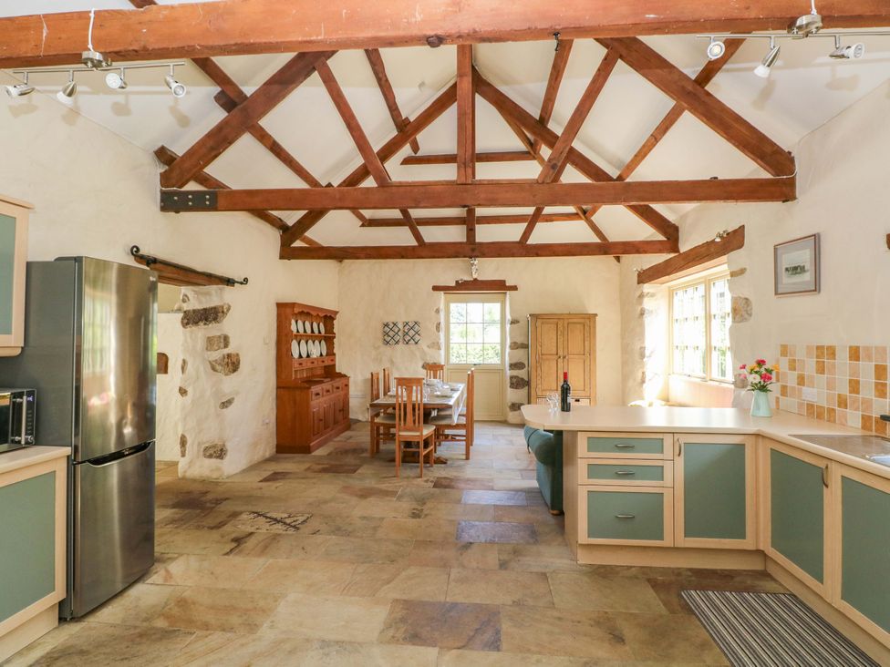 A kitchen with a dining table and chairs at Carreg Las in Haverfordwest