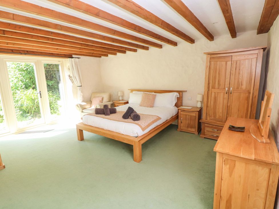 A bedroom with a bed and furniture at Carreg Las in Haverfordwest