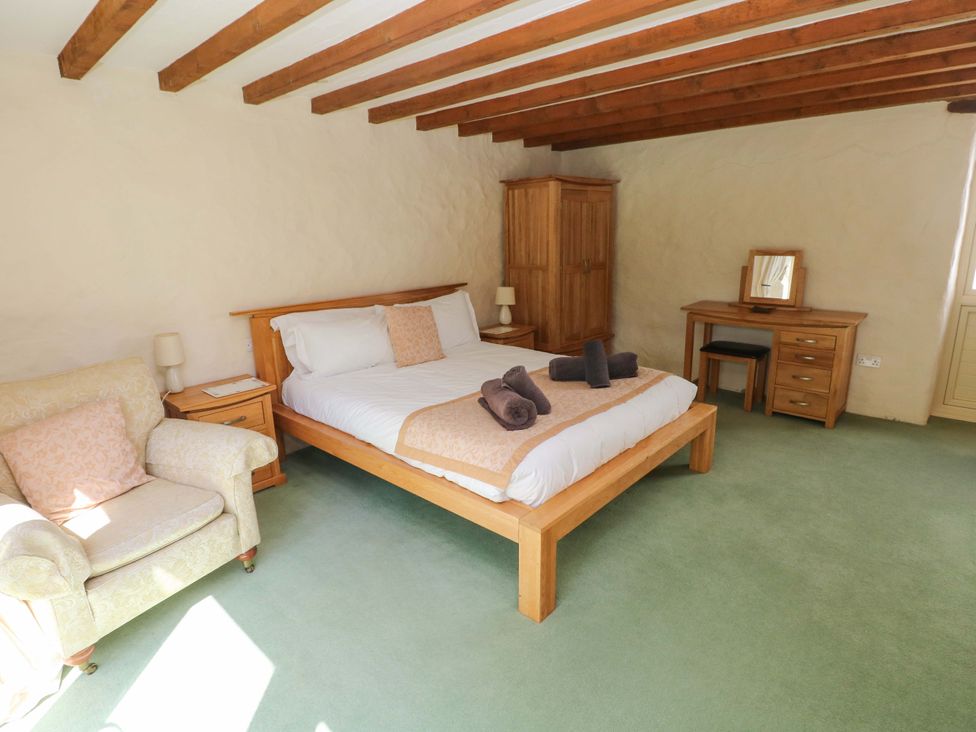 A bedroom with a bed and furniture at Carreg Las in Haverfordwest