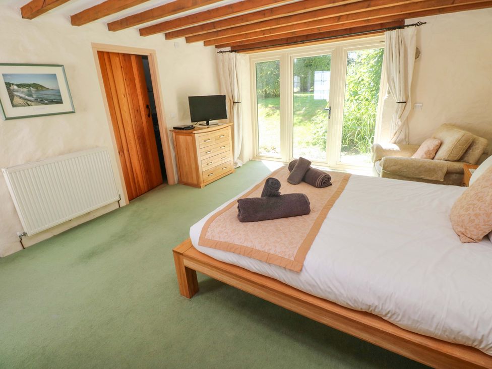 A bedroom with a bed and dresser at Carreg Las in Haverfordwest