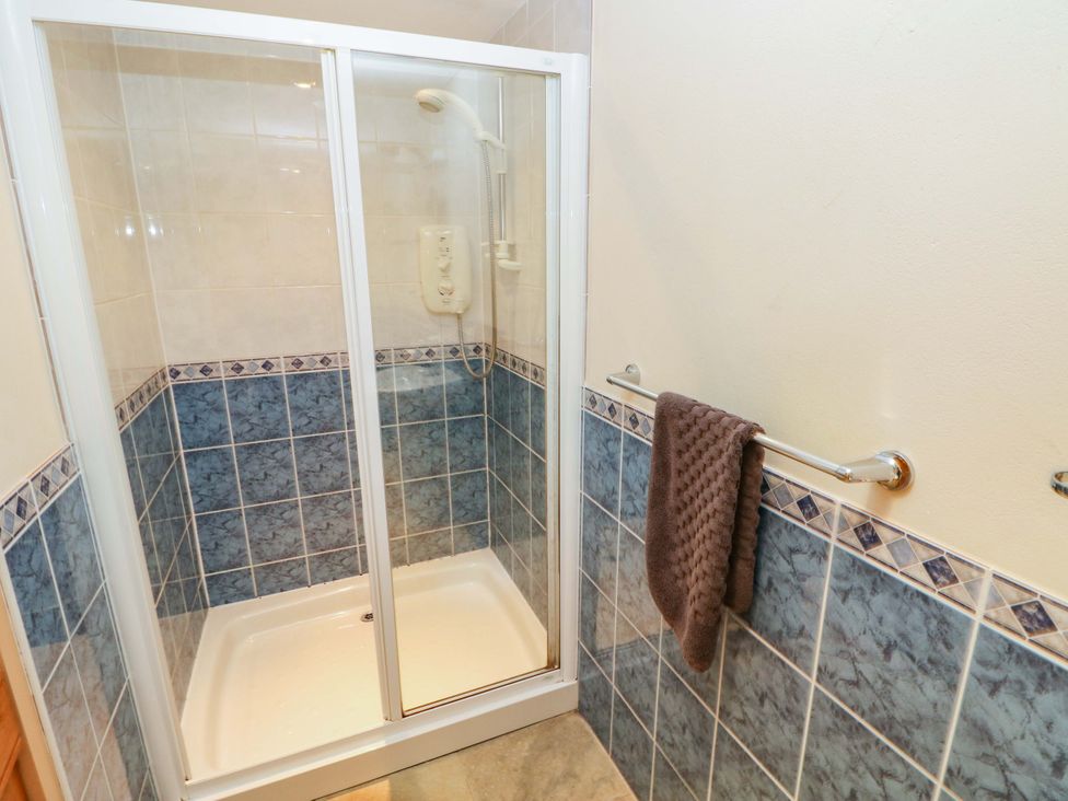 A shower with a towel rack and towel at Carreg Las Haverfordwest