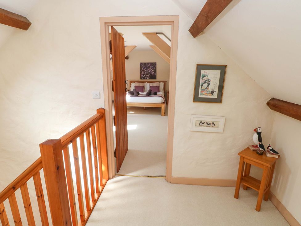 A bedroom with a bed and decor at Carreg Las in Haverfordwest