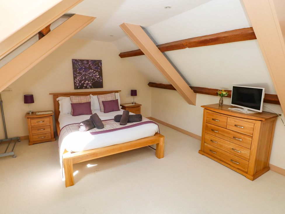 A bedroom with a bed and dresser at Carreg Las in Haverfordwest