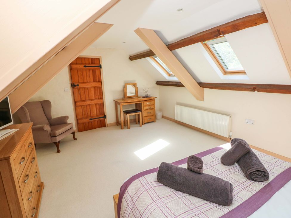 A bedroom with a bed and dresser at Carreg Las Haverfordwest