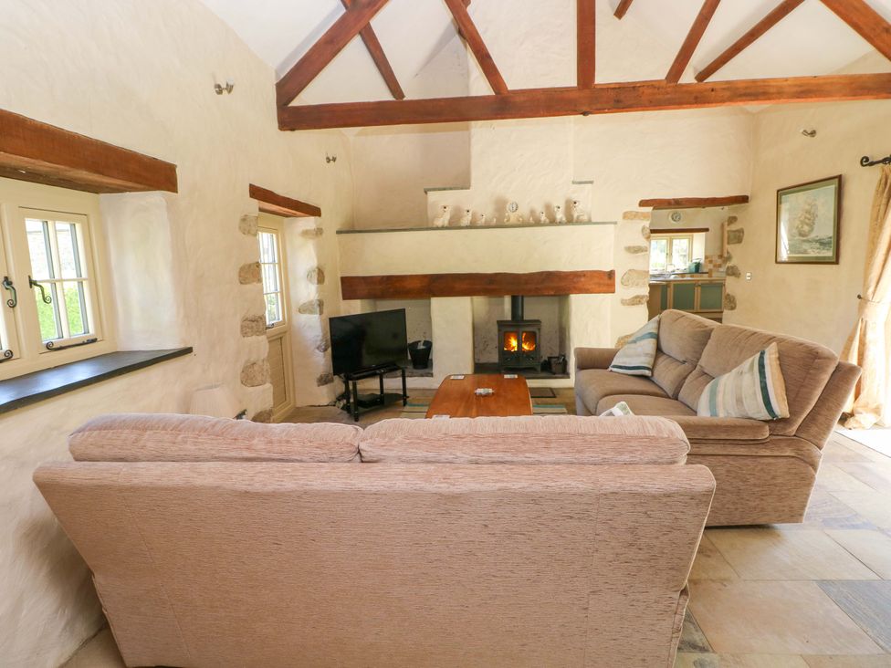 A living room with a sofa and television at Carreg Las, Haverfordwest