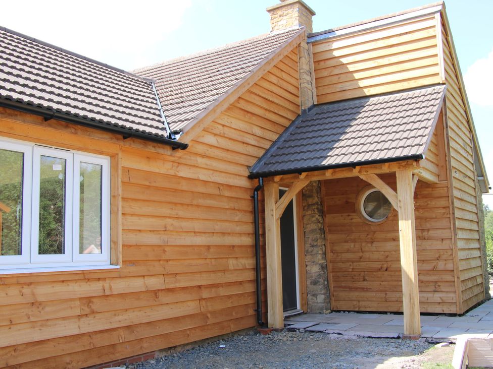 A house exterior with window, door, and patio at Dingle in Kidderminster