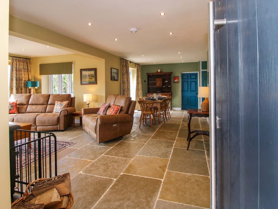 A living room with a sofa and dining table at Dingle in Cleobury Mortimer