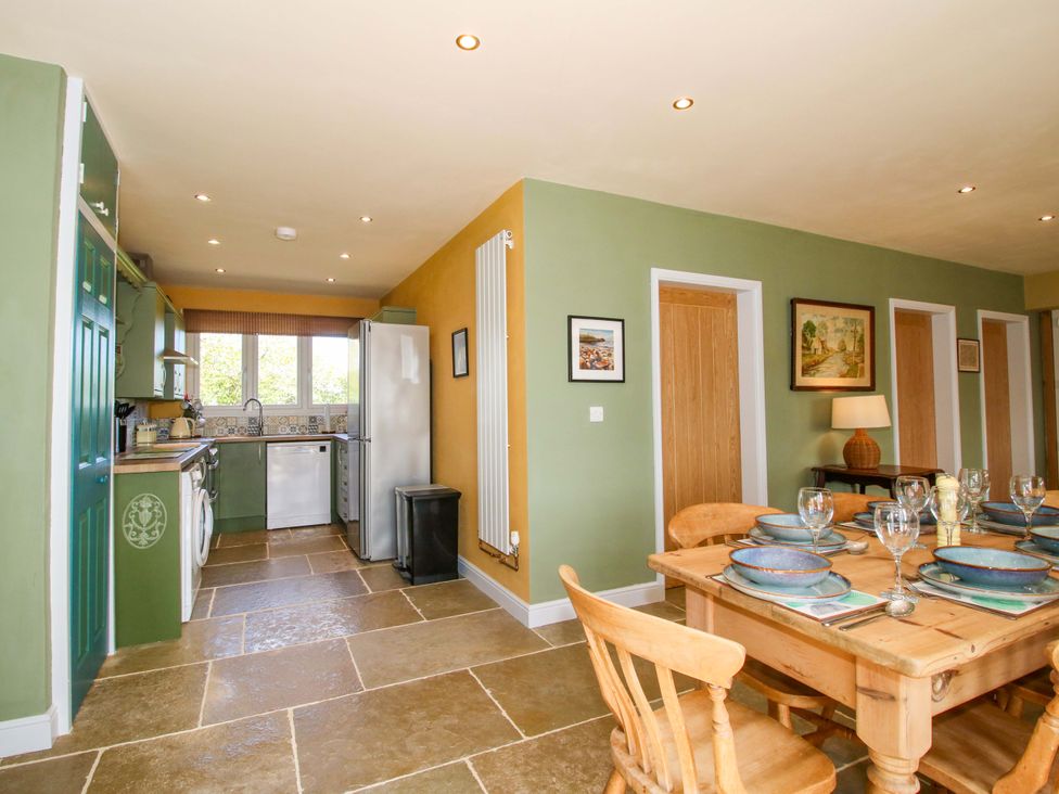 A kitchen with a dining table and chairs at Dingle in Cleobury Mortimer