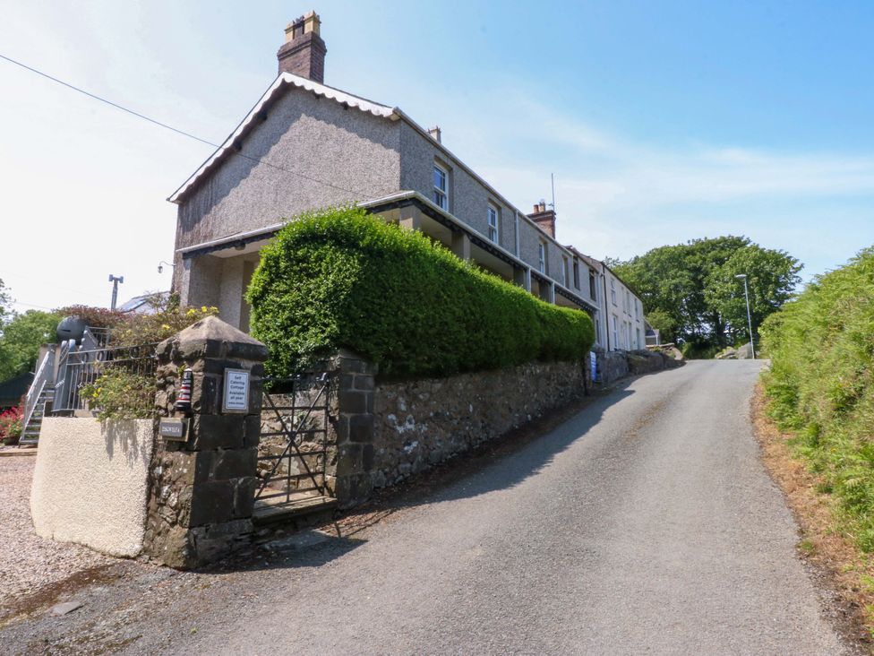 A house with a gate on a gravel road at Disgwylfa Sarn Mellteyrn