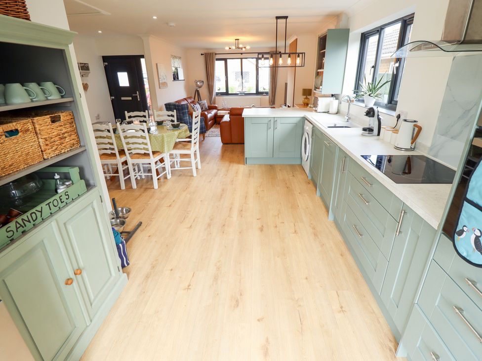 A kitchen with dining area and living space at Sandy Toes in Trusthorpe
