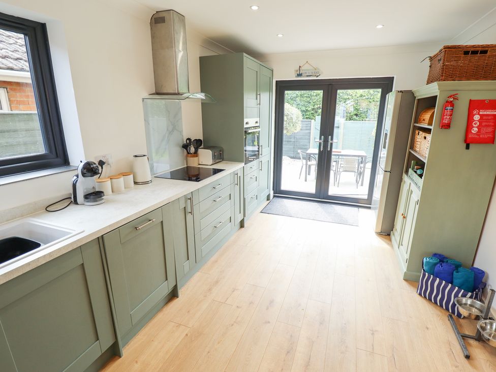 A kitchen with cabinets and appliances at Sandy Toes in Trusthorpe