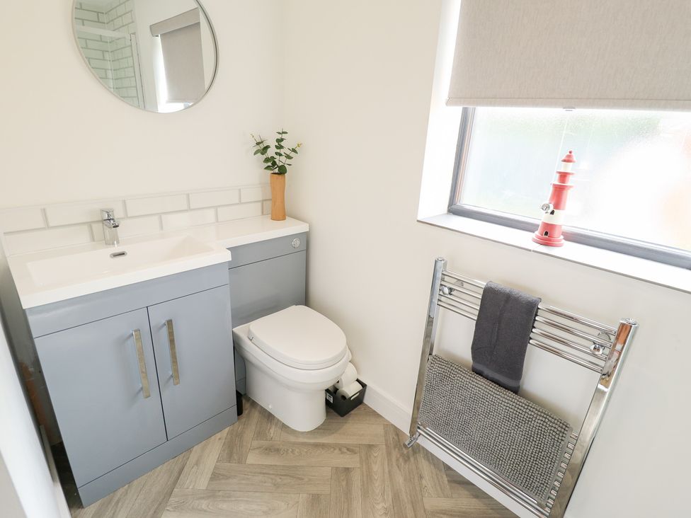 A bathroom with a sink and toilet at Sandy Toes in Trusthorpe