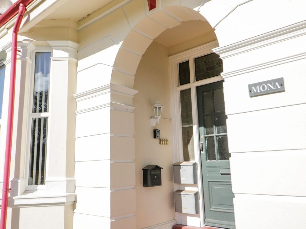An entrance with a door and mailbox at Flat 1A, Mona House in Conwy