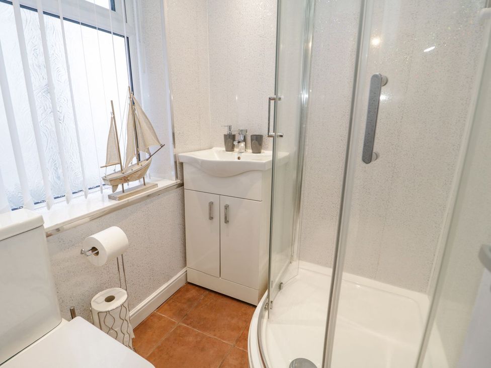 A bathroom with a toilet and washbasin in Flat 1A, Mona House Conwy