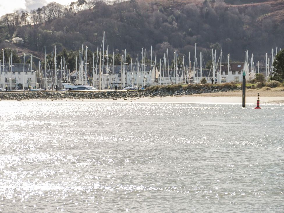 A marina with boats and hills in the background at Flat 1A, Mona House in Conwy