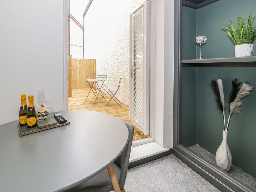 A dining room with a table and chairs at Flat 1, Mona House Conwy