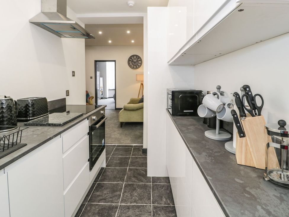 A kitchen with appliances and utensils at Flat 1, Mona House Conwy