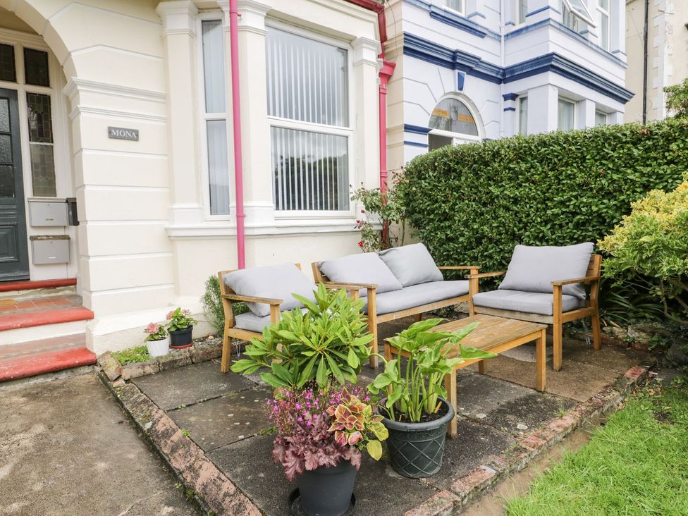 An outdoor seating area with a sofa and table at Flat 1, Mona House in Conwy