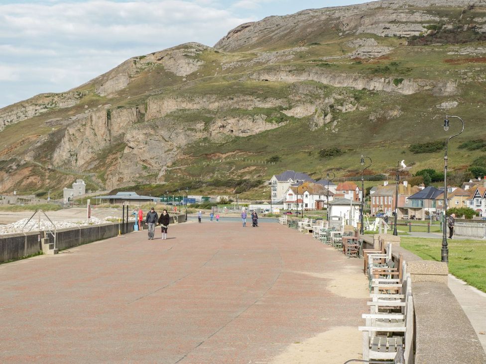 A pathway with people walking and buildings alongside at Flat 1, Mona House in Conwy