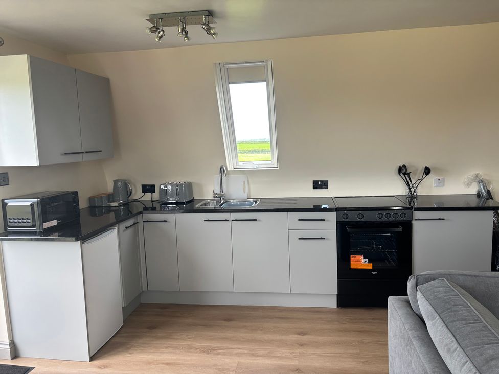 A kitchen with a sink and appliances at Hayes Lodge Coach House in Chulmleigh