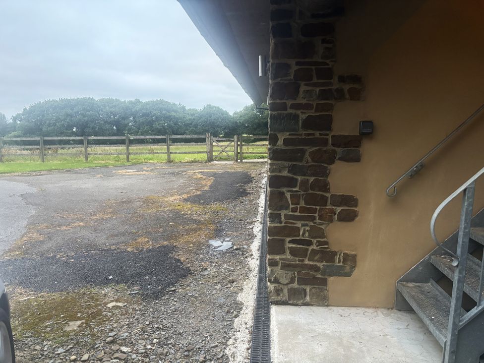 An exterior view showing stairs and gravel area at Hayes Lodge Coach House Ashreigney near Dolton