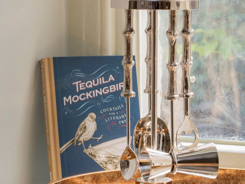 A bar tool set and cocktail book at Apartment 1, 86 Dyer Street, Cirencester