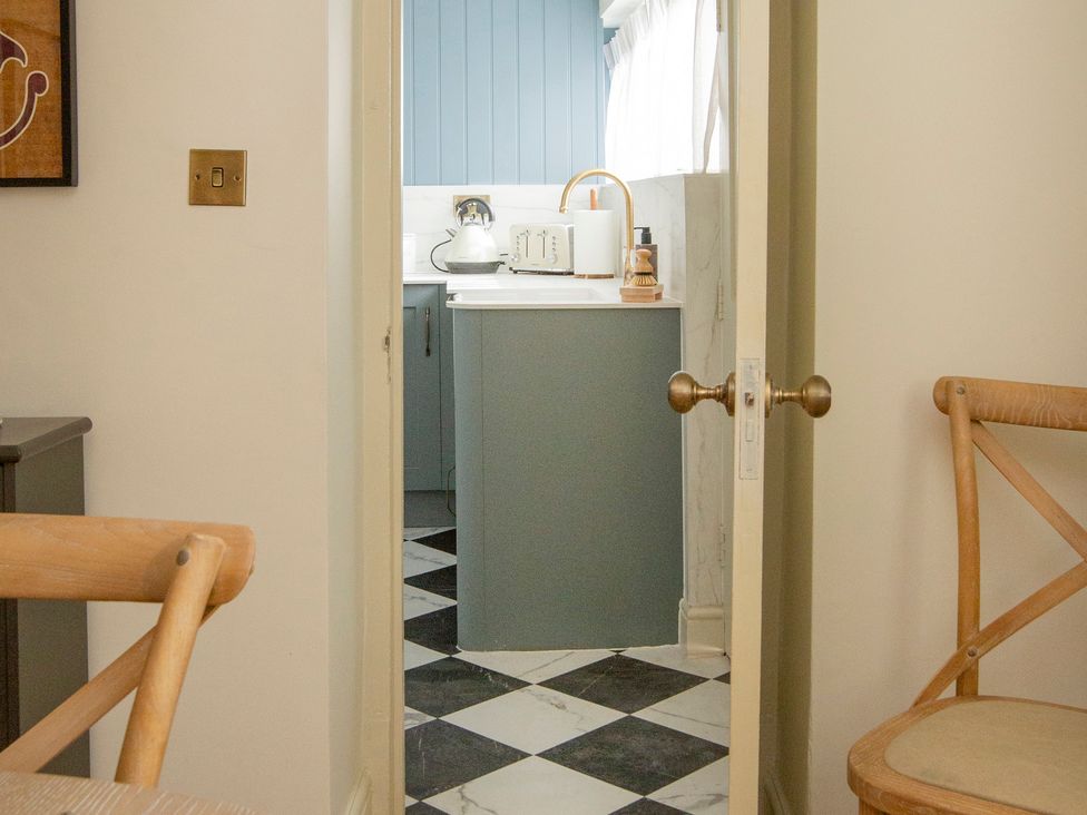 A view from a dining area into the kitchen at Apartment 1, 86 Dyer Street Cirencester