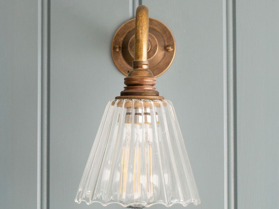 A wall-mounted light fixture with glass shade at Apartment 1, 86 Dyer Street, Cirencester