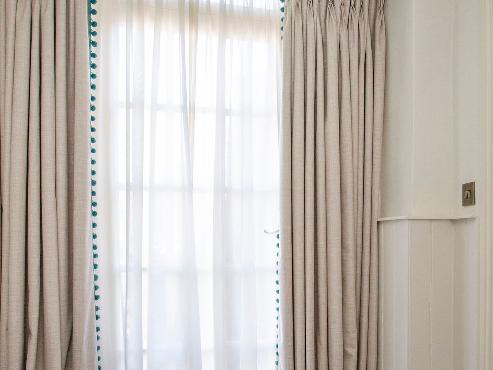 A window with curtains and sheer drapes at Apartment 1, 86 Dyer Street Cirencester