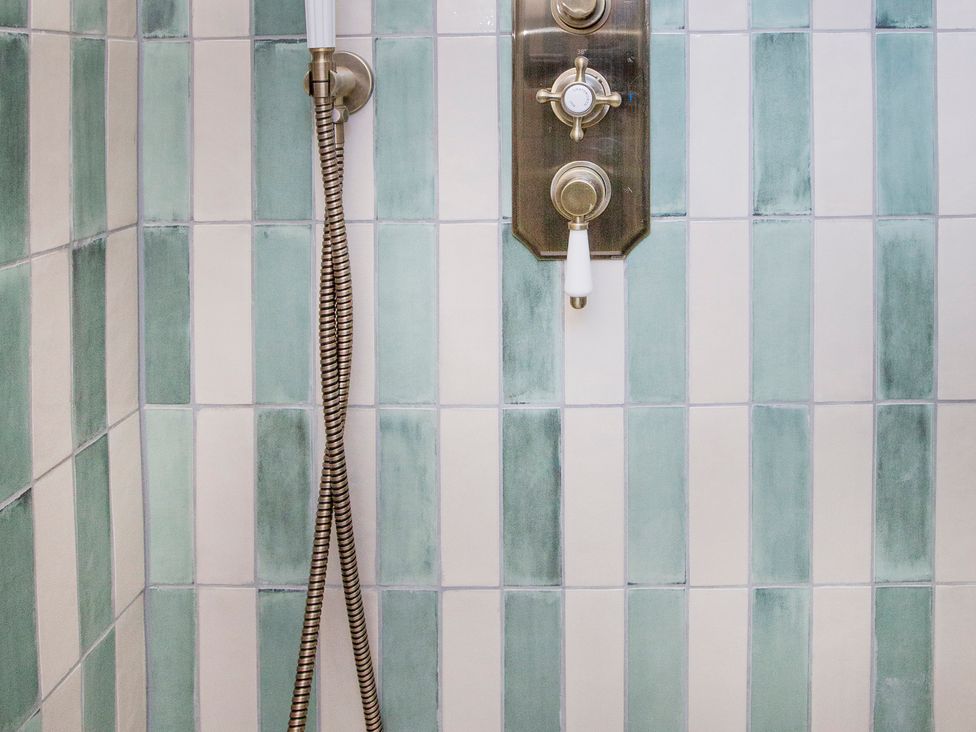 A shower control with tiles in a bathroom at Apartment 1, 86 Dyer Street Cirencester