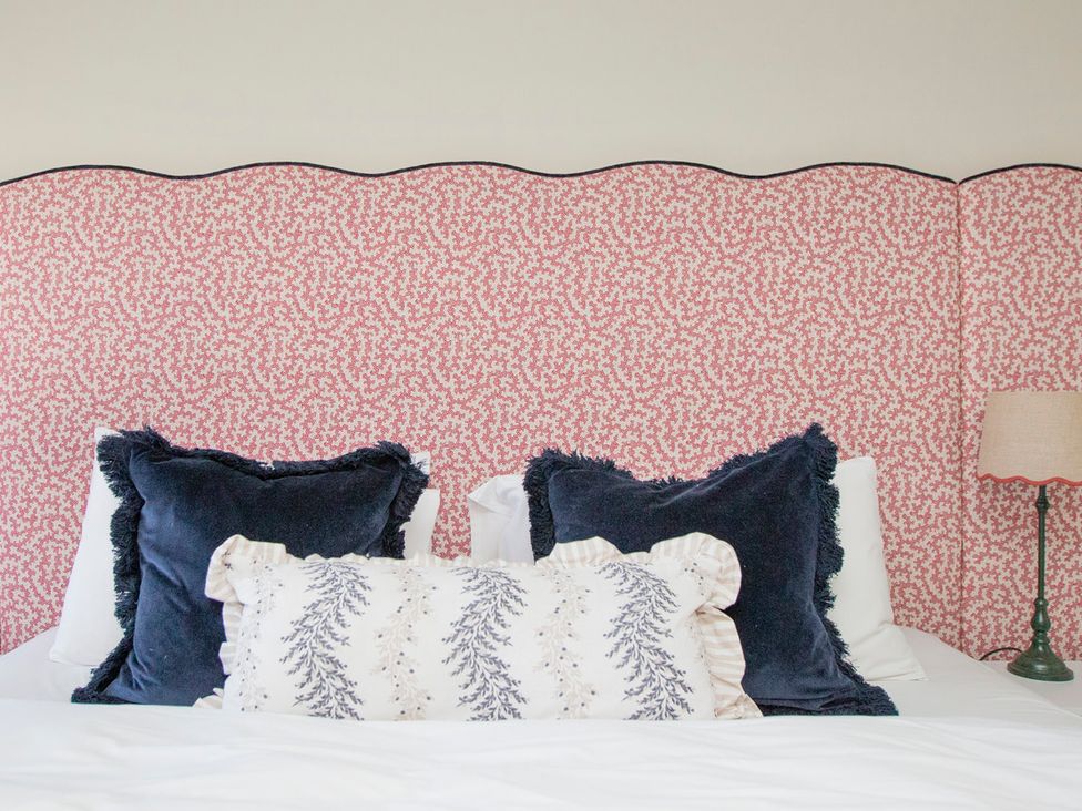 A bedroom with pillows on a bed at Apartment 1, 86 Dyer Street in Cirencester