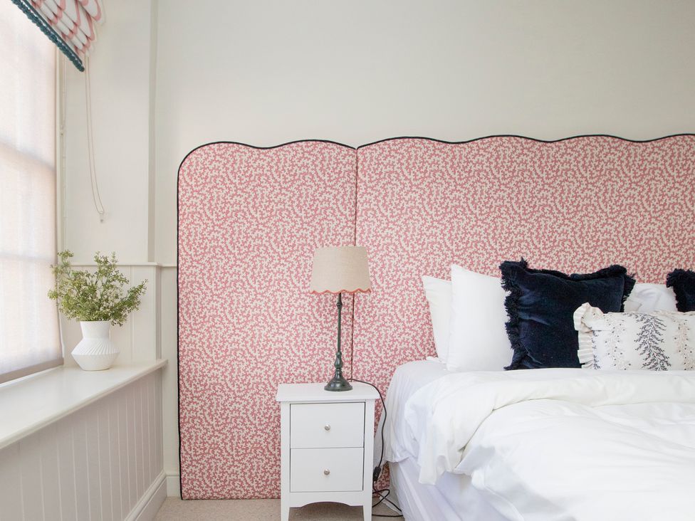 A bedroom with a bed and bedside lamp at Apartment 1, 86 Dyer Street Cirencester