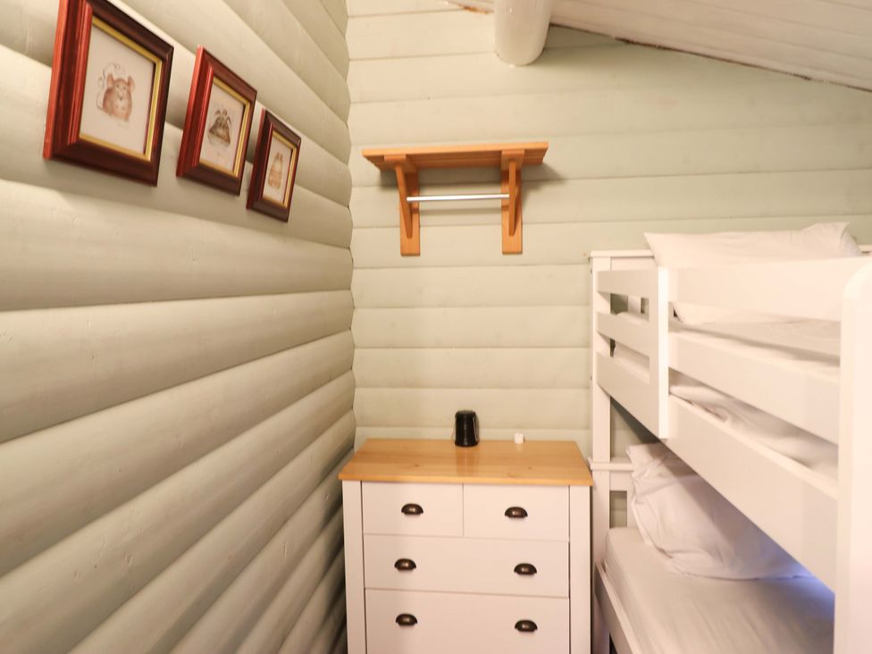 A bedroom with a bunk bed and drawers at Swn Yr Afon - No 333